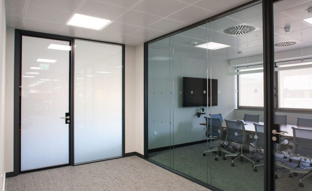 Smart glass partitions in an office meeting room